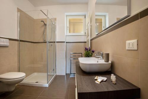 a bathroom with a sink and a toilet and a shower at Residence La Villa Fewo Cristallo in Tignale