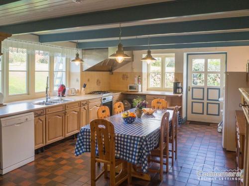a kitchen with a table and chairs in a kitchen at Kill House, Kingstown in Clifden