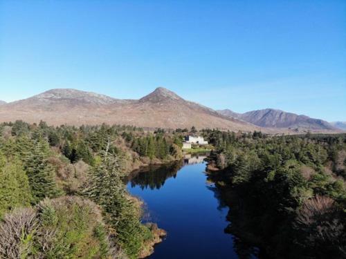 an aerial view of a river with mountains in the background at Kill House, Kingstown in Clifden