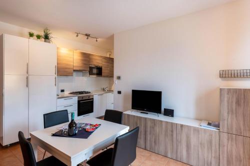 a kitchen and dining room with a table and chairs at Villa Bornico Margherita in Toscolano Maderno