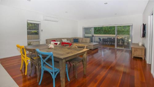 a living room with a wooden table and chairs at Retreat on Manning- Kiama in Kiama