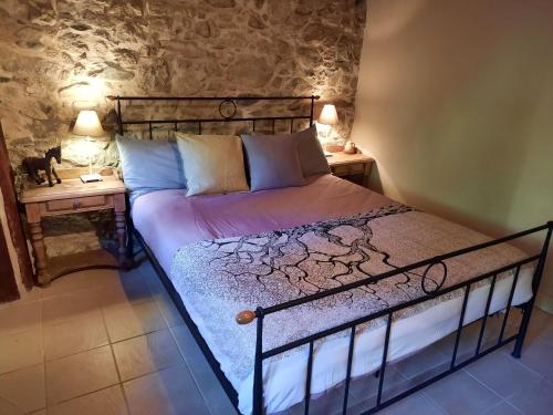 a bed in a room with two night stands at Casa Ribeira in Coentral das Barreiras