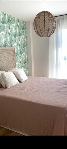 una camera da letto con un grande letto con una coperta rosa di Cordoba Luxury Home a Cordoba