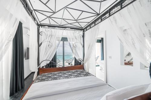a bed in a room with a window at Barjaktar - Luxury Suites & SPA in Ulcinj
