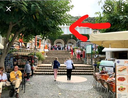 a picture of a red arrow pointing to a group of people at La solara in Anacapri