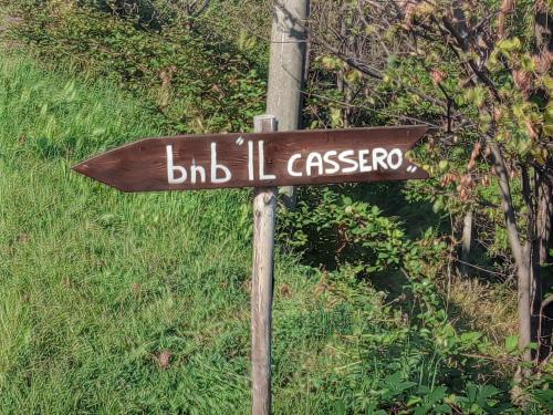 a brown street sign on a wooden pole at Il Càssero in Pomaretto