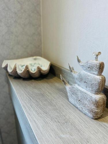 a figurine of a boat on a table with a tray at Sunbird Lodge with Hot Tub in York