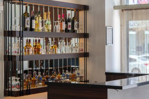 a shelf filled with lots of bottles of alcohol at Lazz By Ketenci Hotel in Izmir