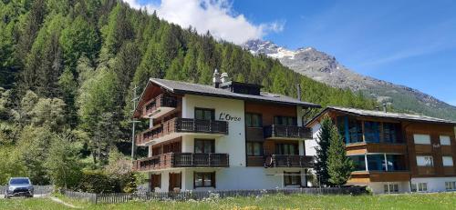 a large building in the middle of a mountain at FREE cable car & bus in the summer Haus L'oree in Saas-Grund
