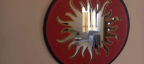 a mirror on a wall with a chandelier at Mila's studio in Kotor