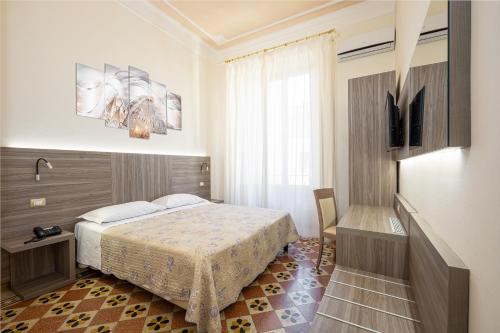 מיטה או מיטות בחדר ב-Astrid Hotel