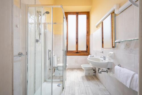 a bathroom with a shower and a sink and a toilet at Astrid Hotel in Florence