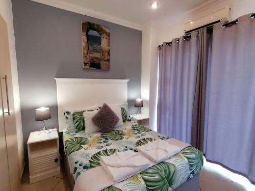 Кровать или кровати в номере Palm View Guest House