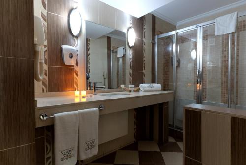 a bathroom with a sink and a shower at Lazz By Ketenci Hotel in Izmir