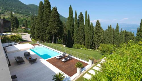 a house with a swimming pool and a patio at Eden Reserve Hotel in Gardone Riviera