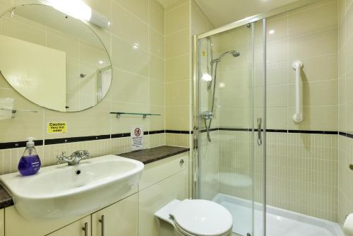 a bathroom with a sink and a shower and a toilet at Melfort Village in Oban