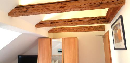 a room with a mirror and a wooden ceiling at Villa Hoffnung in Bad Elster