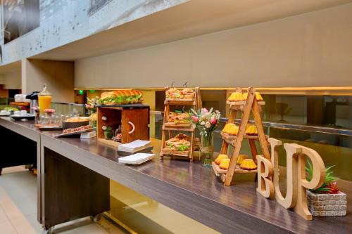 a buffet line with sandwiches and other food at Novotel RJ Santos Dumont in Rio de Janeiro