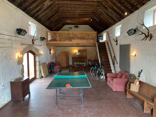 a living room with a ping pong table in it at Border View Cottage in Duddo