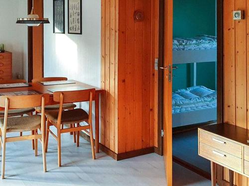 a room with a table and chairs and a bunk bed at 6 person holiday home in Højby-By Traum in Højby