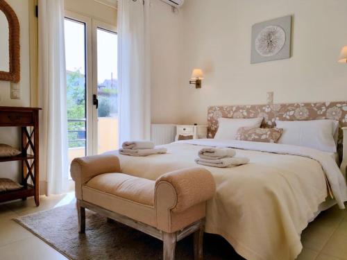 a bedroom with a large bed with two towels on it at Sea Breeze - Home with a View in Bouzéïka
