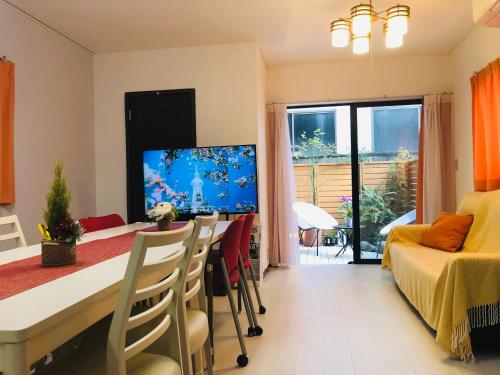 a room with a dining table and a living room at K House in Tokyo