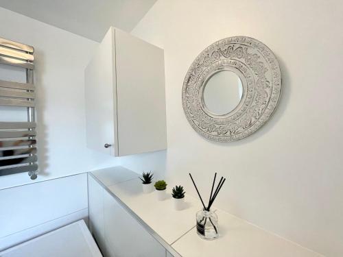 a white bathroom with a mirror on the wall at Comfy 3-Bedroom House in Worksop in Worksop