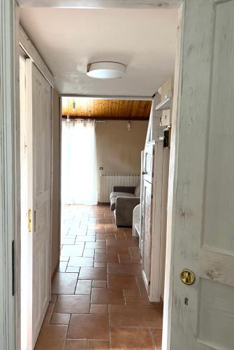 a hallway with a tile floor and a living room at Ai house boutique in Castel di Sangro
