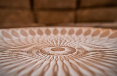 a close up of a metal plate with a spiral pattern at Apartamentos la Encarnación in Ronda