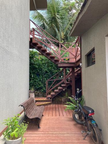 a wooden deck with a staircase and a bike at Flats Baia dos Porcos in Fernando de Noronha