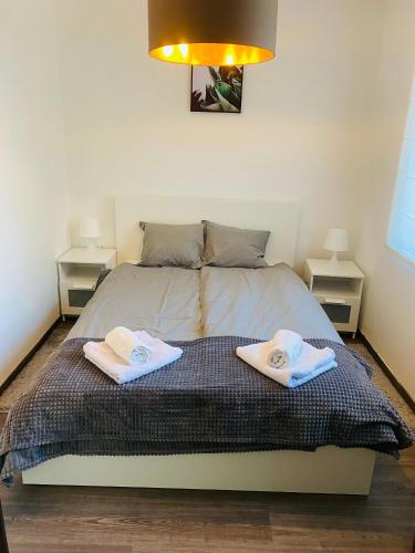 a bedroom with a bed with two towels on it at Villa007 in Zamárdi