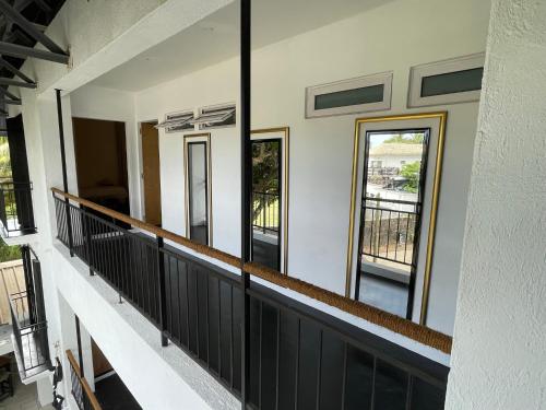 a house with large mirrors on a balcony at Cosy Guest House Sous le Badamier in Grand Baie