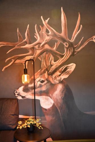 a painting of a deer head on a wall at Masonic Arms Gatehouse in Gatehouse of Fleet