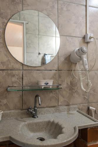 a bathroom with a sink and a mirror at Pousada da Carmô in Fernando de Noronha