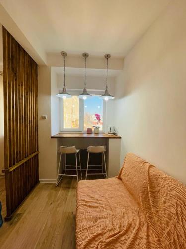 a bedroom with a bed and a kitchen with a table at 1Bed Flat Central Bucharest in Bucharest