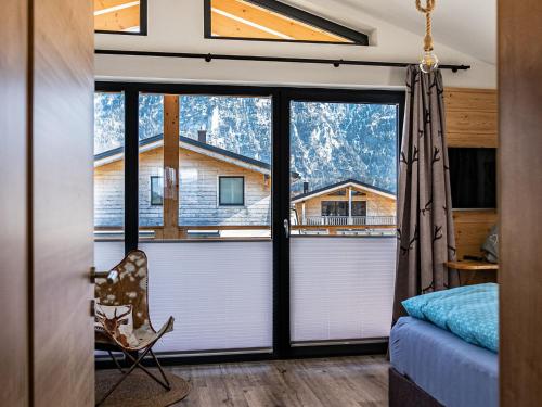 a bedroom with a view of a mountain at Chalet Charivari Inzell, Inzell in Inzell