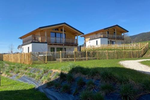 a house with a fence in front of it at Chalet Charivari Inzell, Inzell in Inzell