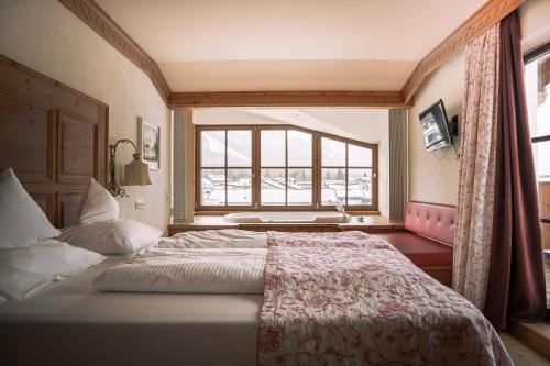 Letto o letti in una camera di Hotel Tirolerhof - Familotel Zugspitze