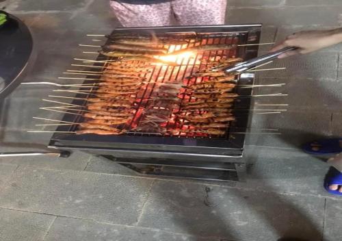 a grill with many different types of food on it at Win Villa Coffee in Da Lat