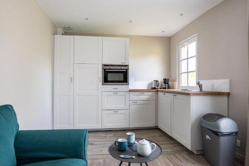 - une cuisine avec un canapé et une table dans une chambre dans l'établissement Gîte Taumain, à Cancale