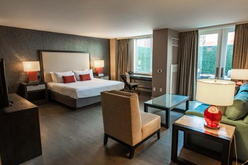 Habitación de hotel con cama y sala de estar. en 2500 Penn, a Placemakr Experience, en Washington