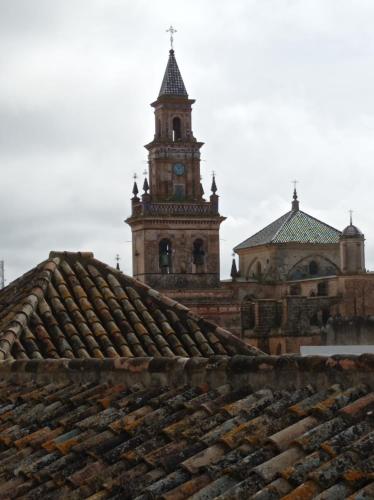 a clock tower on top of a building with a roof at Fernan Caballero in Carmona