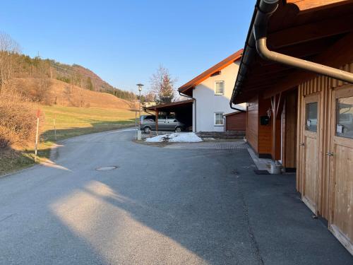 a driveway of a house with a truck parked in the driveway at Sonnenchalet mit Sauna in Kötschach