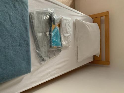a bed with plastic wrap on it next to a table at Gîtes grands groupes - Château des Forges Gouville in Gouville-sur-Mer