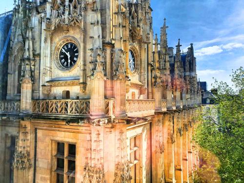 a large building with a clock tower on it at Suite Saint Lô Rouen (Centre Historique) in Rouen