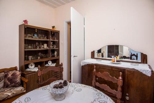a room with a mirror and a table and a chair at Christina's House in Argostoli
