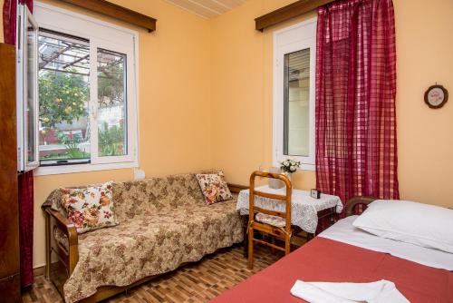 a living room with a couch and a bed and a window at Christina's House in Argostoli