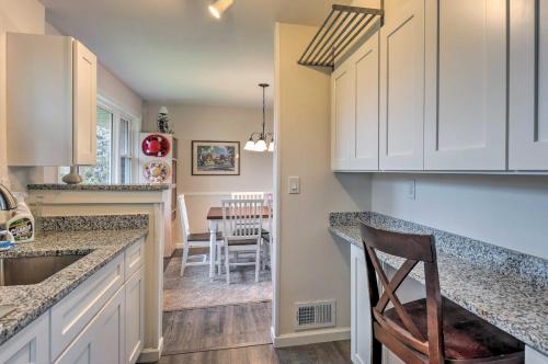 a kitchen with white cabinets and a dining room at New Carrollton Home Between Baltimore and DC! in New Carrollton