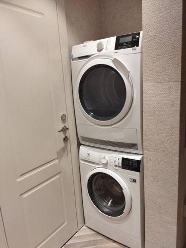 a washer and dryer next to a white door at KOTEL HOTEL in Jerusalem