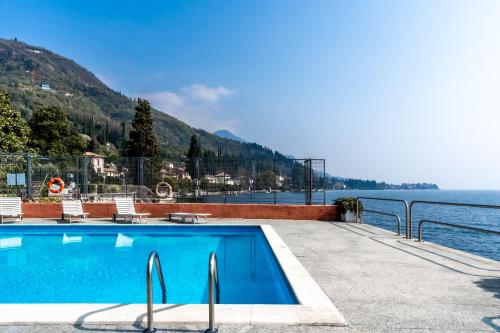 a swimming pool with a view of the water at Casa Vistabella in Salò